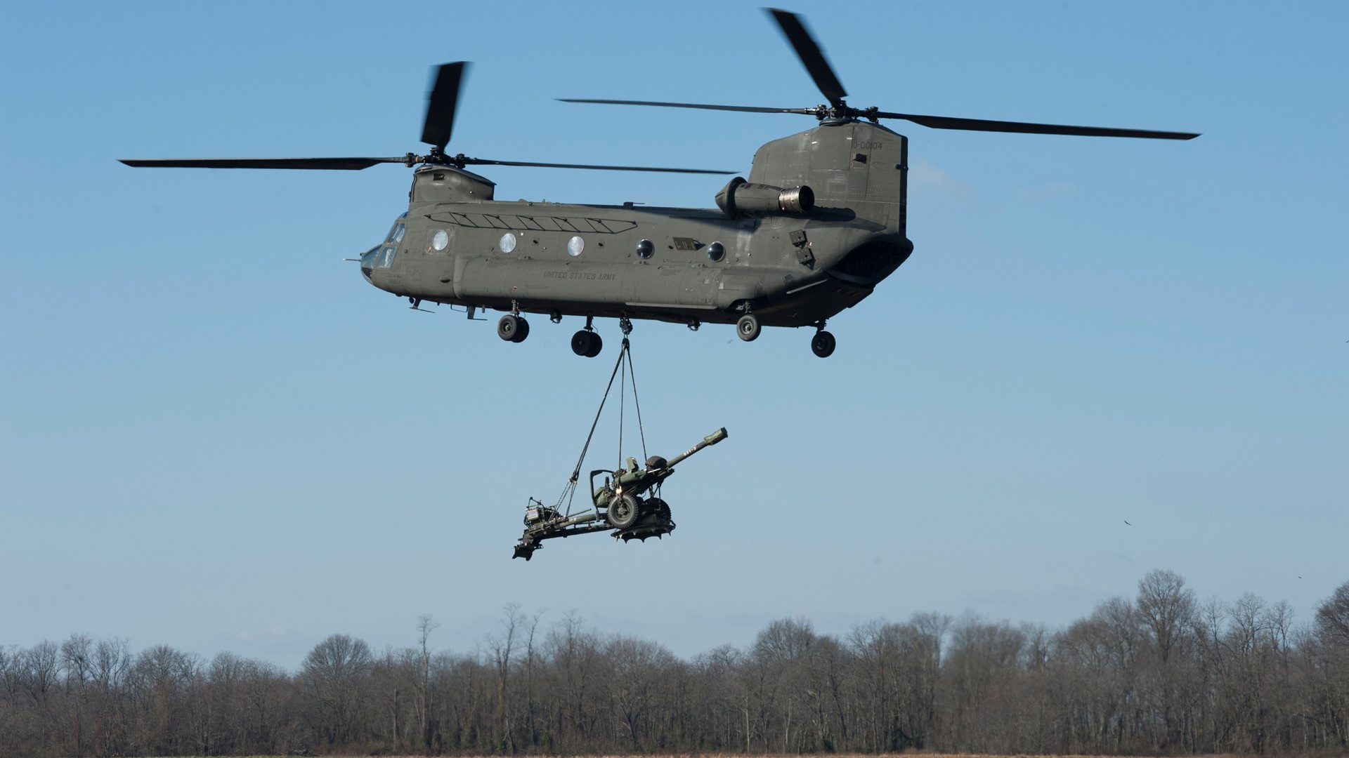 A military helicopter lifting up a mortar